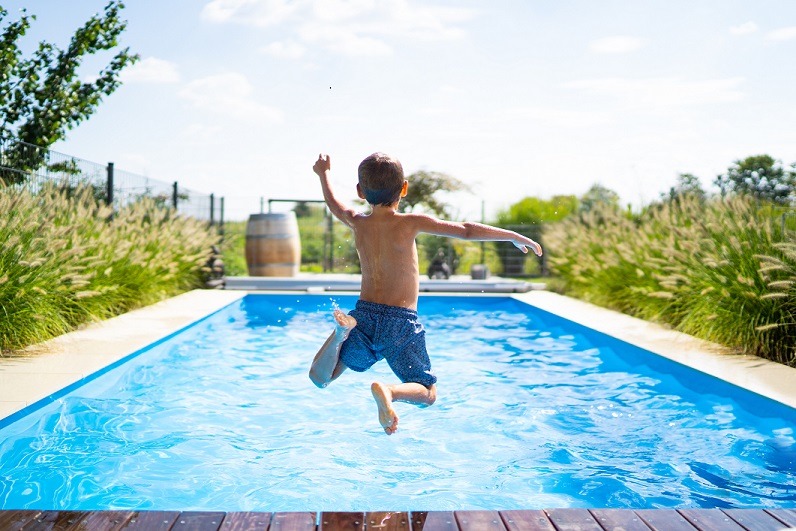 Boy jumping in swimming pool