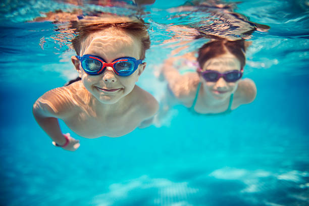 Kids enjoying underwater swim in the pool