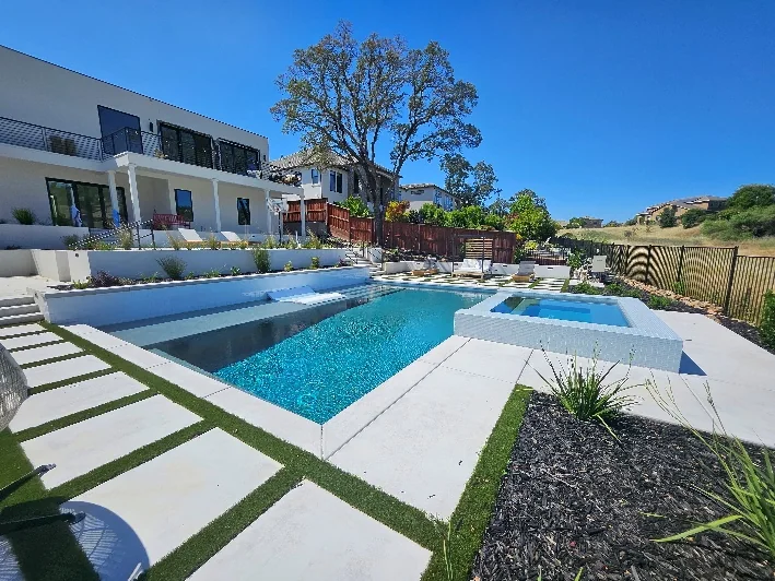 Finished Folsom pool and raised spa with terraced hardscape