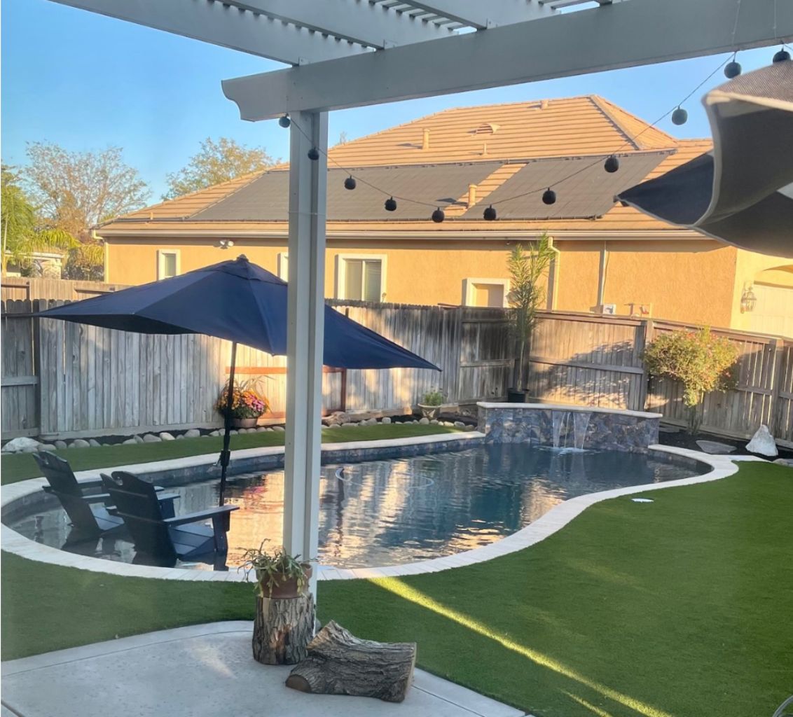 Freeform shaped pool approx. 360 square feet with raised wall with sheer descent water feature and a Cabo shelf.