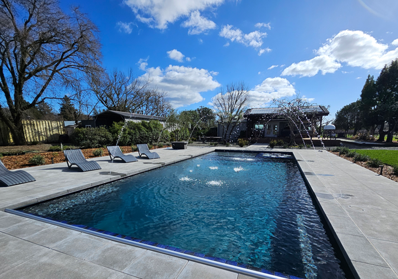 Large rectngular pool approx 800 square feet with an automatic pool cover and spa and deck jets in Napa, California