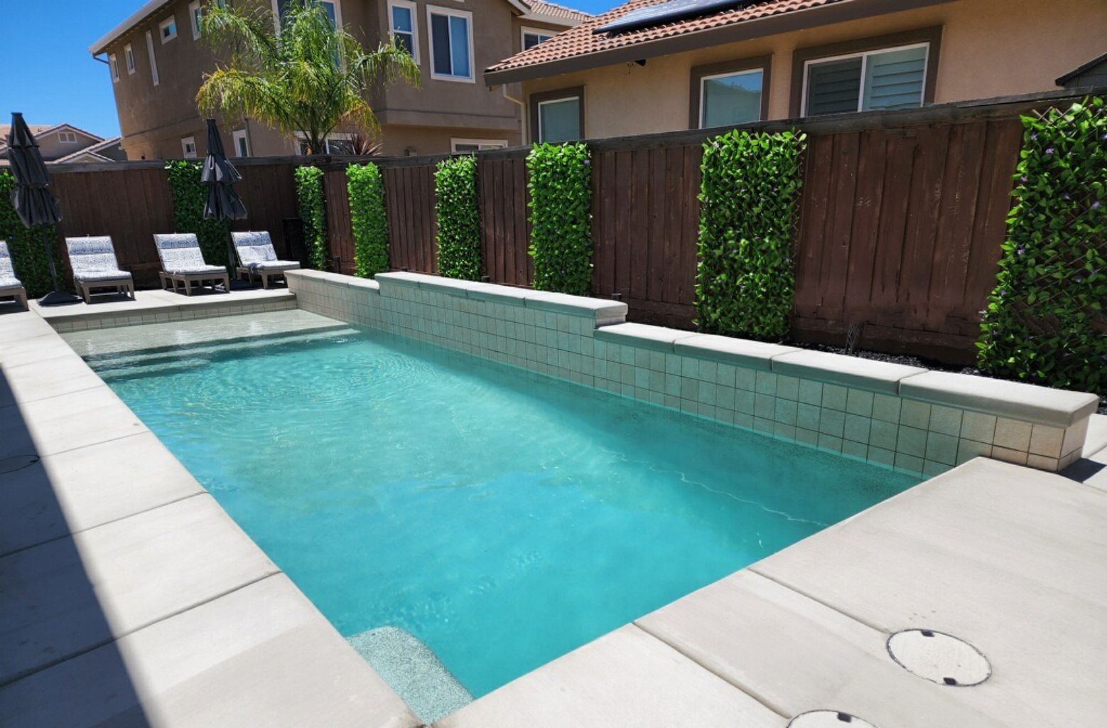 Rectangular shaped pool approx. 300 square feet with raised tiered wall and Cabo shelf.