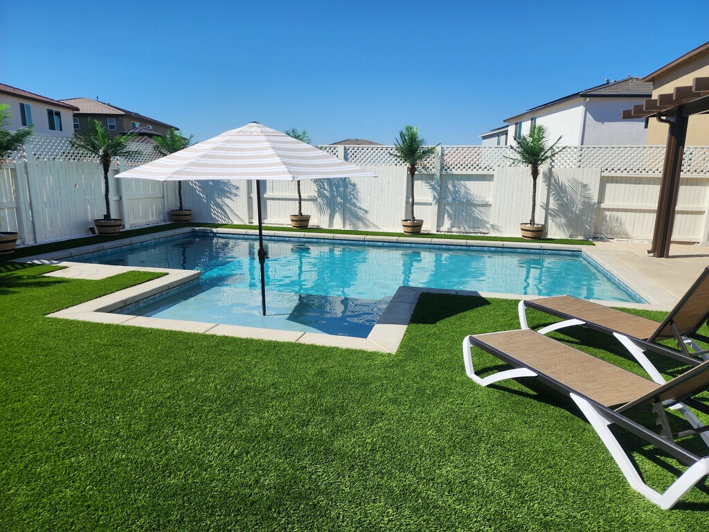Rectangular shaped pool with bumped out Cabo shelf and turf
