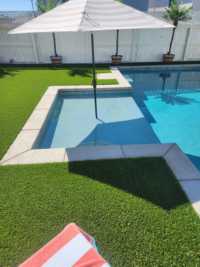 Rectangular shaped pool with bumped out Cabo shelf and turf