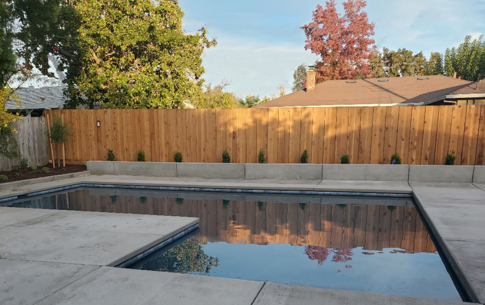 Rectangular shaped pool with larged bumped out Cabo shelf and concrete decking.