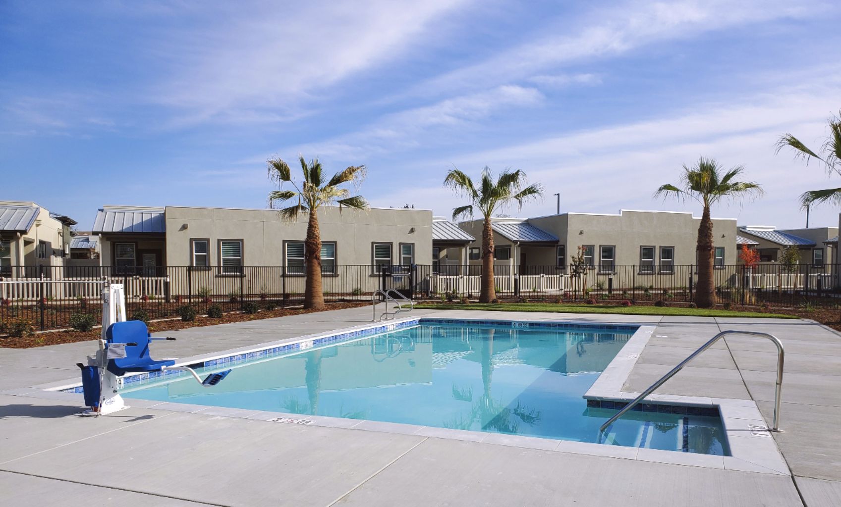 Commercial swimming pool for senior living facility in Elk Grove with bumped out entry steps.