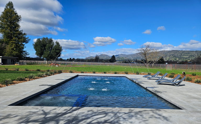 Large rectangular pool approximately 800 square feet with an automatic pool cover and spa and deck jets in Napa, California
