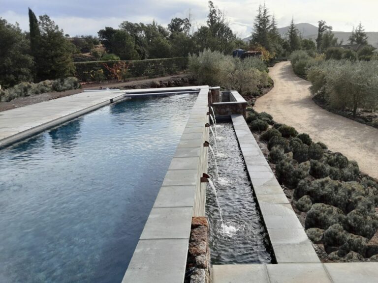 Rectangular pool in Napa County with an automatic pool cover and scupper water features